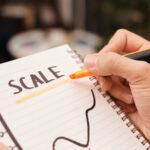 Scale Affiliate Marketing - Person Drawing on a Notebook